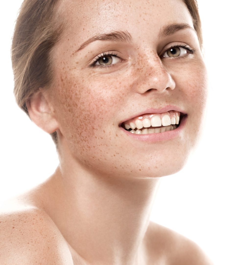 Woman freckle happy young beautiful studio portrait with healthy skin